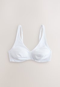Weißer Soft-Cup-BH mit verstellbaren Trägern, flach auf einem beigen Hintergrund liegend, zeigt Vorderseite und Nahtdetails.