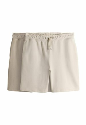 Dve dvojice svetlobéžových elastických šortiek sťahovacím šnúrkou v páse, jedna preložená za druhú na bielom pozadí.