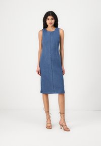 Džinsinis midi suknelė, be rankovių ir su apvaliu iškirpimu. Turi centrinius siūlus ir tiesų pjūvį, vidutinio mėlynumo plovimas. Be raštų ar dekoracijų.