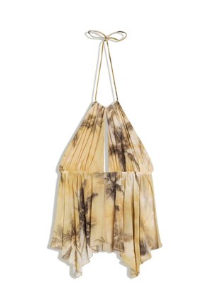 Robe jaune à col licou imprimée de palmiers, taille froncée, ourlet asymétrique en forme de mouchoir et fermeture par lien au cou.