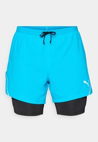 Turkise sportsshorts med sort inderside, elastisk talje og snor, med et hvidt logo og sidelomme.