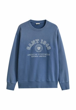 Blue crewneck sweatshirt with "GANT 1949" text, circular logo, and "American Sportswear New Haven - Connecticut" printed on front.