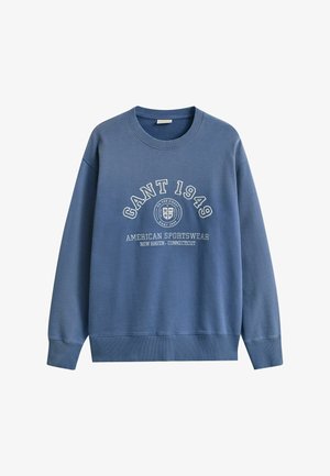 Blue crewneck sweatshirt with "GANT 1949" text, circular logo, and "American Sportswear New Haven - Connecticut" printed on front.