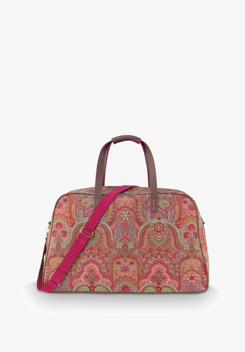 Duffle bag with a colorful floral and paisley pattern, made of fabric. Features pink striped shoulder strap and brown handles. Zippered closure.