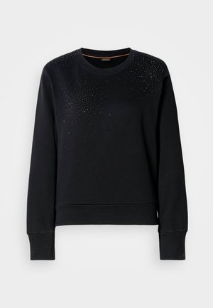 Musta collegepaita pehmeästä kankaasta, jossa on pyöreä kaula-aukko ja pitkät hihat. Yläosassa on pienten hopeisten niittien gradientti.