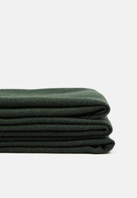 Dark green folded blanket with a soft texture, featuring smooth edges and a simple design, stacked neatly against a white background.