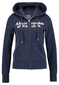 Marineblå zip-up hættetrøje i blødt stof med kenguruposer, snøre og hvidt logo-tekst "Abercrombie & Fitch" på forsiden.