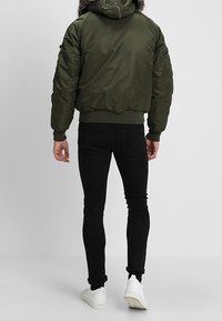 Alpha Industries Mezisezónní bunda  - dark green