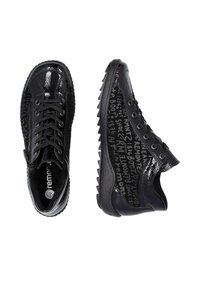 Black patent leather sneakers with textured upper, lace-up design, and rubber outsole. Features graphic text pattern on sides.