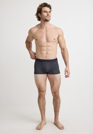 Navy blue boxer shorts with a colorful abstract pattern, elastic waistband, and a snug fit, made from soft, flexible fabric.