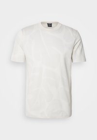 Vit bomull t-shirt med ett subtilt bladmönster, rundhals, korta ärmar och en vanlig passform. Slät textur, inga synliga detaljer.