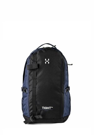 Zaino nero e blu navy con cinghie frontali, manico superiore e logo "TIGHT Medium" sul pannello frontale.