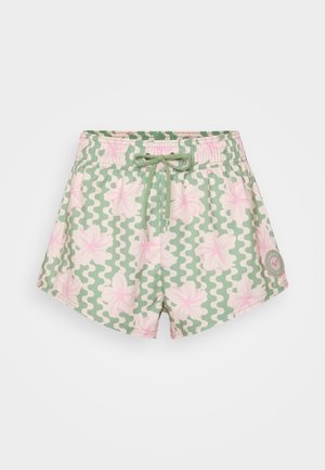 Green patterned swim shorts featuring pink floral design, elastic waistband with drawstring, and circular logo patch on the bottom left.