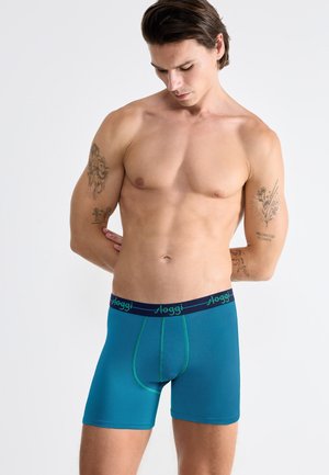 Boxer da uomo color teal con elastico blu navy, caratterizzati dal marchio verde "Aloggi". Texture liscia, design aderente e dettagli di cucitura a contrasto.