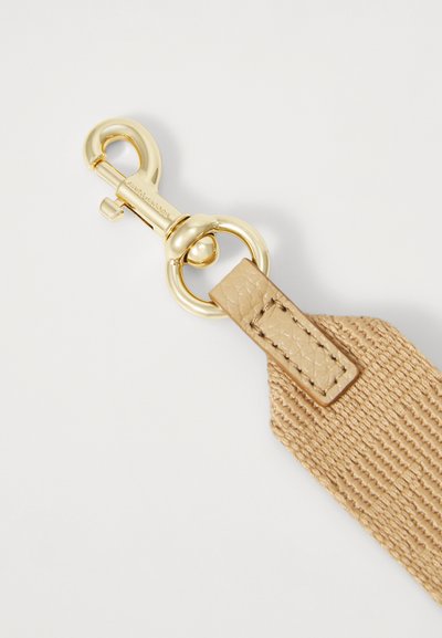 Gold-tone metal clasp engraved with Marc Jacobs attached to a beige woven fabric strap with leather detailing.
