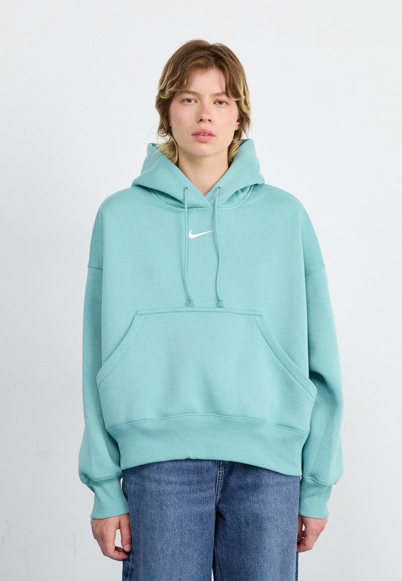 Haut en molleton vert menthe en mélange de coton, doté d'une poche frontale, de cordons de serrage et d'un logo Nike blanc sur la poitrine. Poignets et ourlet côtelés.