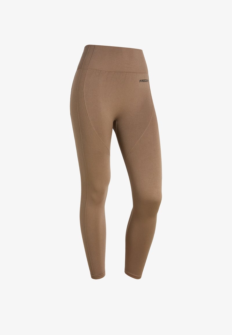 Ruskohi korkeavyötäröiset legginsit, jotka on valmistettu joustavasta kankaasta, ja joissa on sileä pinta, tiukka muotoilu ja korostetut sivusaumat.