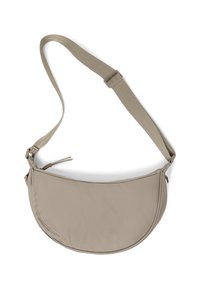Beige shoulder bag with a curved shape, made of soft fabric. Features an adjustable strap and a zippered pocket for secure storage.