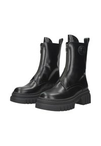 Stivaletti neri in pelle con suola in gomma spessa, chiusura con cerniera frontale e dettaglio del logo di lato. Texture liscia con cuciture minime.