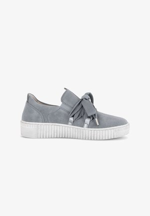 Gray suede sneaker with thick white grooved sole and wide fabric laces tied in a bow on a white background.
