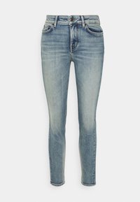 Jeans ajustados de color azul claro, fabricados en denim con un acabado desgastado, cierre de botón, cinco bolsillos y sutilezas en los detalles de costura a lo largo de las costuras.