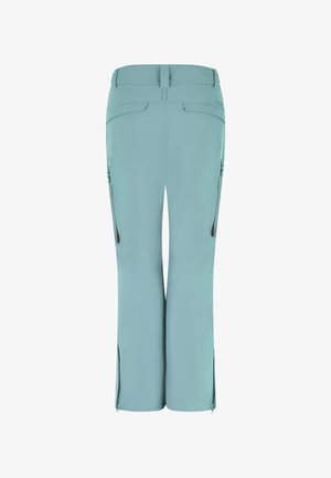 Helleblaue Hose mit glatter Textur, ausgestattet mit seitlichen Reißverschlusstaschen und Schlitzen an den Knöcheln. Entworfen für Komfort und Bewegungsfreiheit.