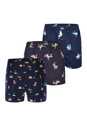Three navy boxer shorts with different playful prints: lounging sloths, cartoon donkeys, and surfing ducks with surfboards.