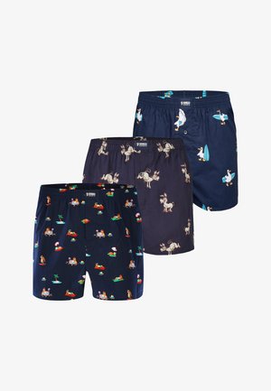 Three navy boxer shorts with different playful prints: lounging sloths, cartoon donkeys, and surfing ducks with surfboards.