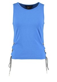 Niebieska bezrękawnik z miękkiej mieszanki bawełny, z regulowanymi wiązaniami po bokach w biało-czarne paski. Okrągły dekolt i luźny fason.
