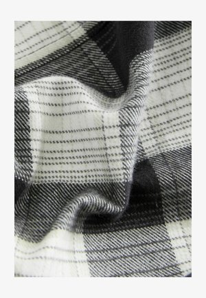 Plaid kangas mustri mustade, valgete ja hallide toonidega, pehme tekstuuri ning erinevate ruudustikega, sisaldades nii õhukesi kui ka paksu jooni.