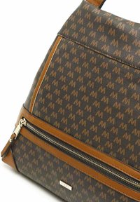Brown fabric backpack with a patterned surface, featuring leather accents, a zippered pocket, and a textured, geometric design.