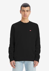 Zwarte sweatshirt met lange mouwen, ribgebreide manchetten en zoom, met een klein rood Levi's-logo op de borst. Van een zachte katoenen mix.