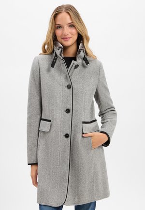 Gray herringbone coat features black accents, a high collar with fasteners, and two front pockets. It has a tailored fit and button closure.