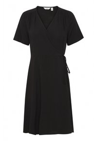 Robe noire enveloppante à manches courtes, décolleté en V, détails froncés et fermeture à nouer sur le côté. Fabriquée en matière douce et lisse.