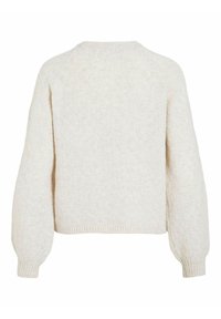 Tekstūrēts bēšs džemperis ar ribotām aprocēm un apakšmalu, ar apaļu kaklu un kvadrātveida siluetu. Audumam ir smalkas krāsu variācijas.