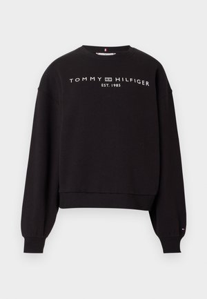 Black crewneck sweatshirt with long sleeves, ribbed cuffs and hem, featuring "Tommy Hilfiger EST. 1985" text and logo on chest.