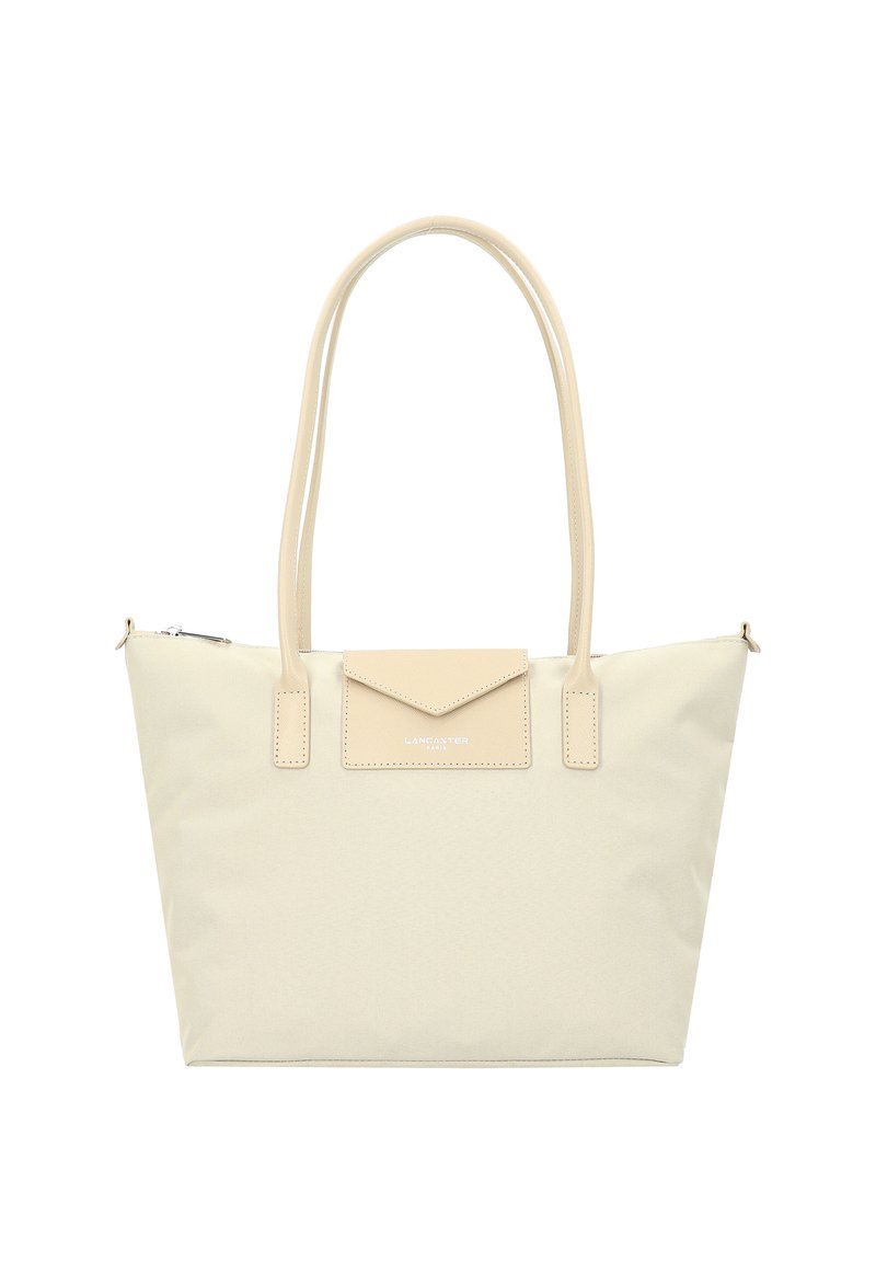 Borsa a tote in canvas beige con dettagli in pelle liscia, forma strutturata, due manici e una piccola tasca con patta sul davanti. Chiusura superiore con zip.