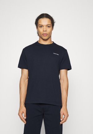 Navy blue cotton t-shirt with short sleeves. Features a small white "Calvin Klein" logo on the chest. Simple, relaxed fit design.