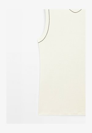 Sleeveless cream top in soft fabric with a V-neck and contrasting thin black stitching along the edges. Simple design with no patterns.
