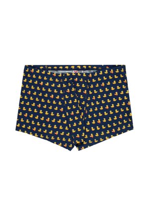 Boxer blu navy con un motivo completo di piccoli paperelle gialle di gomma, alcune con fiocchi rossi, distesi in piano.