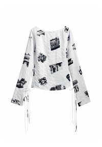 Top alb cu mânecă lungă, cu imprimeuri grafice negre, având un decolteu rotund și închideri cu legături la mâneci, realizat dintr-un material texturat.
