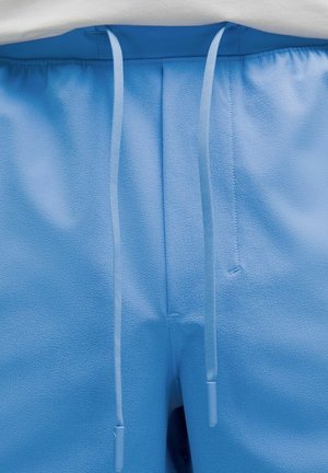 Light blue shorts with a textured surface, featuring a drawstring closure and flat front pockets. Smooth fabric with no visible patterns.