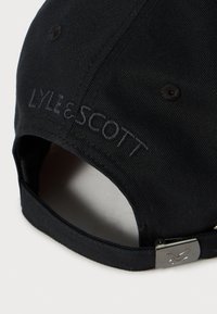 Casquette de baseball noire avec le texte brodé "LYLE & SCOTT" et une boucle en métal réglable avec un logo d'oiseau sur la sangle arrière.