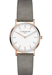 Rondvormig horloge met een witte wijzerplaat, kast in roségoudkleur, en grijze leren band. Bevat minimalistische uurmarkers en een enkele kroon.