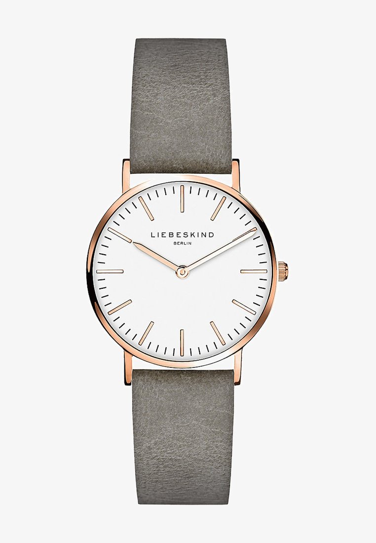Rondvormig horloge met een witte wijzerplaat, kast in roségoudkleur, en grijze leren band. Bevat minimalistische uurmarkers en een enkele kroon.