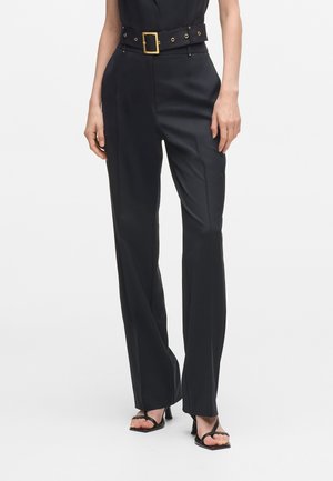 Black tailored trousers with a wide leg, featuring a contrasting gold buckle belt. Smooth fabric with a polished finish, front pockets included.