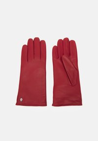 Guanti in pelle rossa con una texture liscia, design a cinque dita e un piccolo dettaglio a forma di teschio sul polsino. Cuciture finemente lavorate.