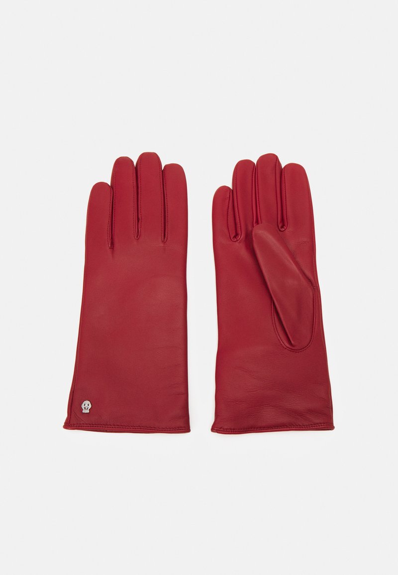 Guanti in pelle rossa con una texture liscia, design a cinque dita e un piccolo dettaglio a forma di teschio sul polsino. Cuciture finemente lavorate.