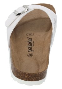 White cork-soled sandal featuring a smooth white upper, decorative silver buckle, and a textured brown insole with brand name "Palado" printed inside.