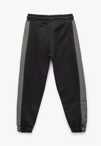 Zwarte sweatpants met grijze zijpanelen, elastische tailleband en cuffs; gemaakt van een zachte katoenmix met een gladde textuur.
